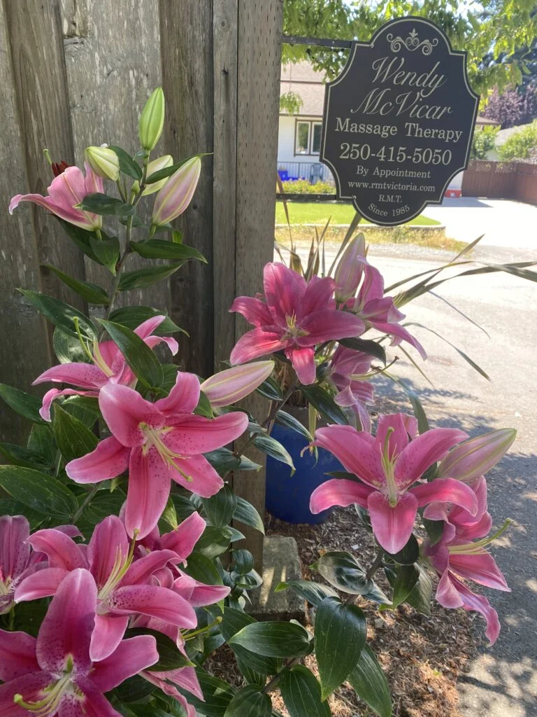 Flowers beside the Wendy McVicar Massage Therapy sign
